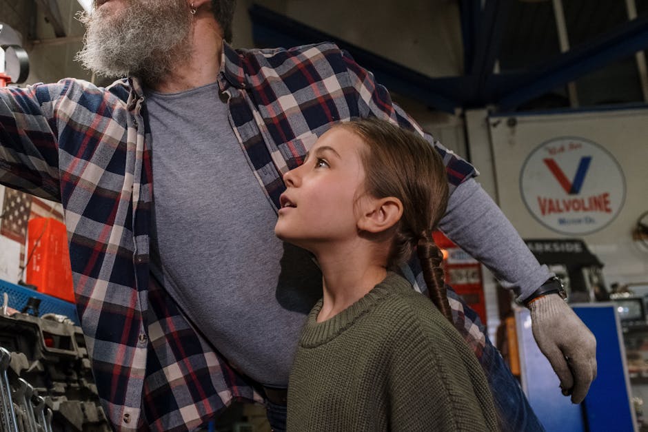 Father and daughter bonding while working together in a garage workshop.